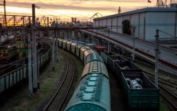 View from the railway bridge to freight trains at sunset.